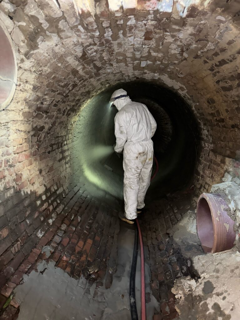 Crew member working inside a large pipe